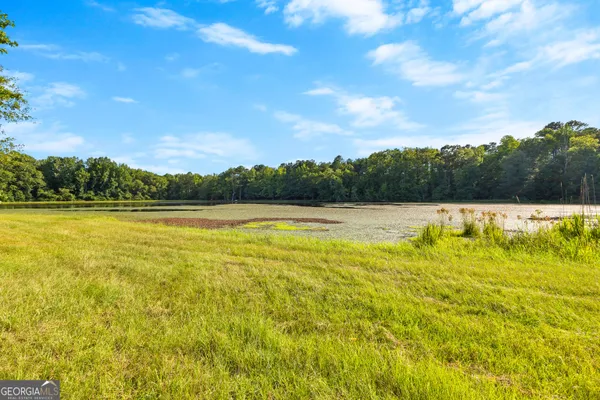 an aerial view of a house with a yard and lake view