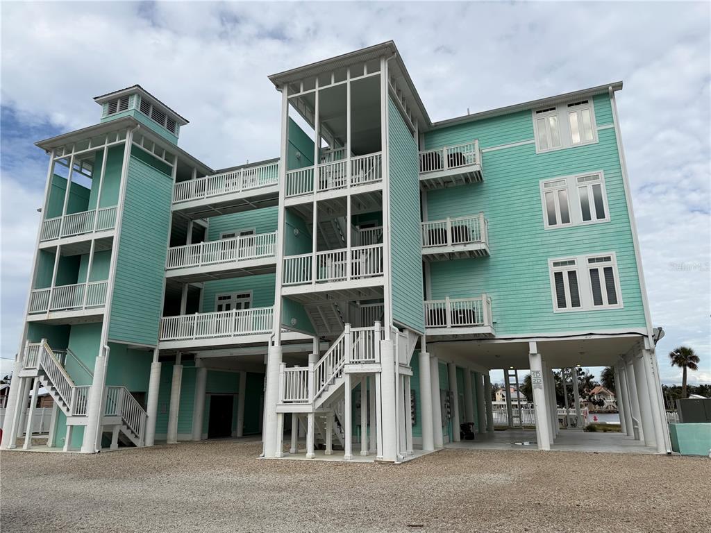 6990 Southwest Highway 358, Unit 2B Steinhatchee, FL 32359 - Photo 1 of 13 a front view of a building with a lot of windows