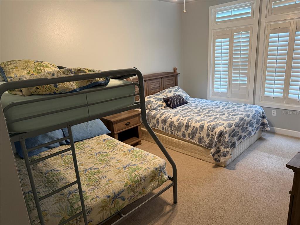6990 Southwest Highway 358, Unit 2B Steinhatchee, FL 32359 - Photo 12 of 13 a bedroom with two beds and a window