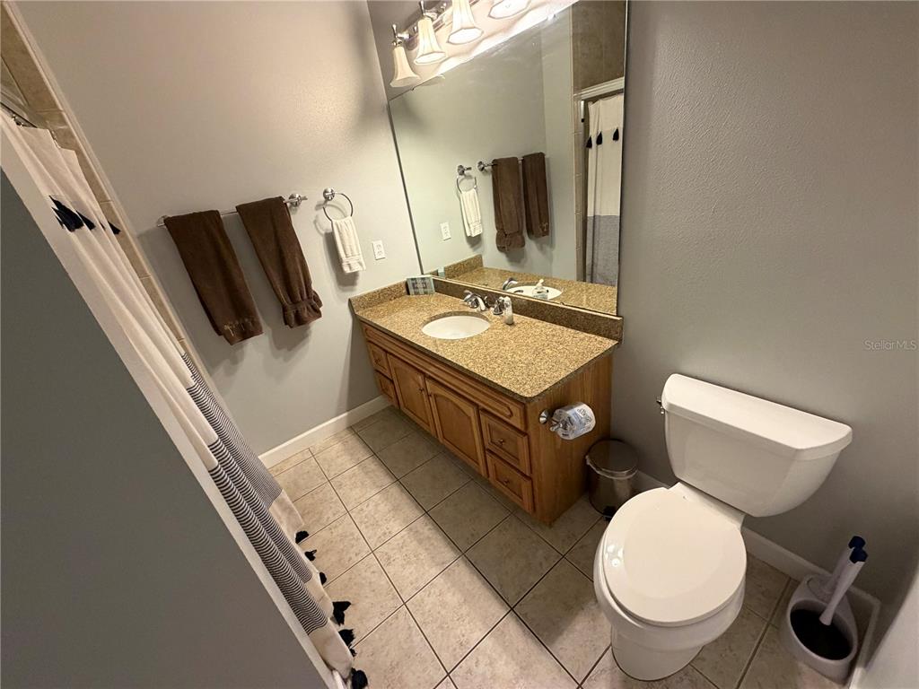 6990 Southwest Highway 358, Unit 2B Steinhatchee, FL 32359 - Photo 13 of 13 a bathroom with a toilet sink and mirror