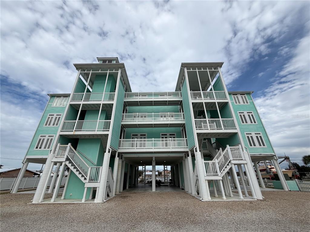 6990 Southwest Highway 358, Unit 2B Steinhatchee, FL 32359 - Photo 2 of 13 a front view of a house with a balcony