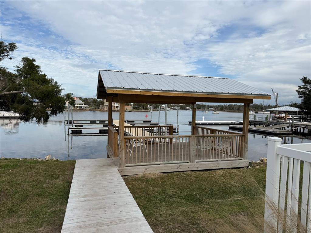 6990 Southwest Highway 358, Unit 2B Steinhatchee, FL 32359 - Photo 4 of 13 a view of a swimming pool with outdoor seating and plants