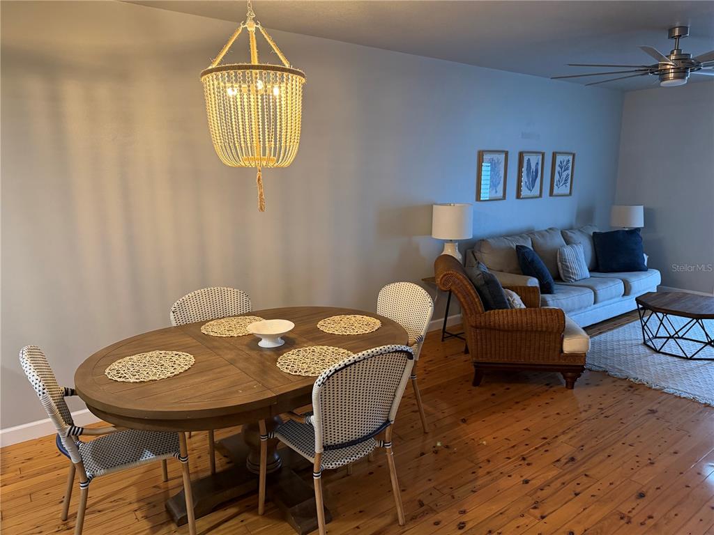 6990 Southwest Highway 358, Unit 2B Steinhatchee, FL 32359 - Photo 8 of 13 a view of a dining room with furniture and wooden floor
