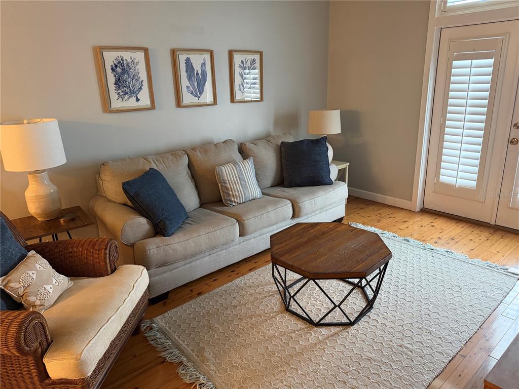6990 Southwest Highway 358, Unit 2B Steinhatchee, FL 32359 - Photo 9 of 13 a living room with furniture and a wooden floor
