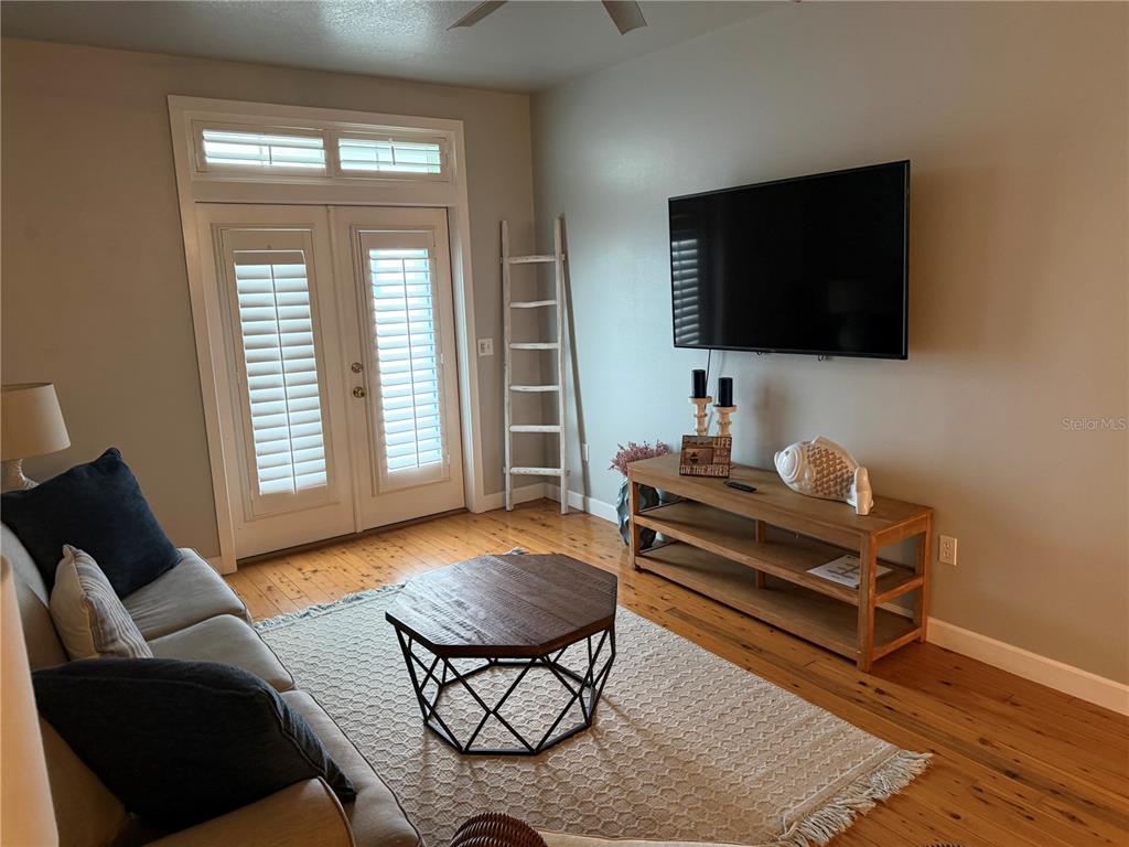 6990 Southwest Highway 358, Unit 2B Steinhatchee, FL 32359 - Photo 10 of 13 a living room with furniture and a flat screen tv