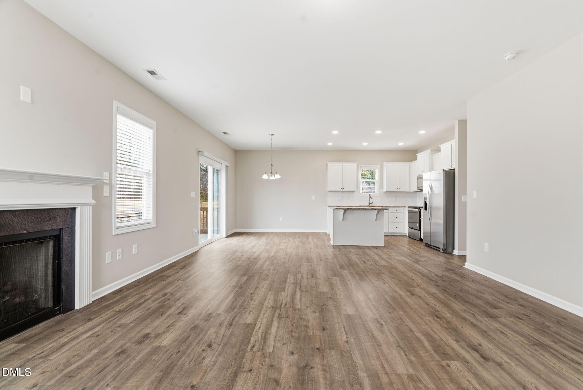 48 Weathervane Dr. Zebulon, NC 27597 - Photo 18 of 68 a view of kitchen with wooden floor and a fireplace