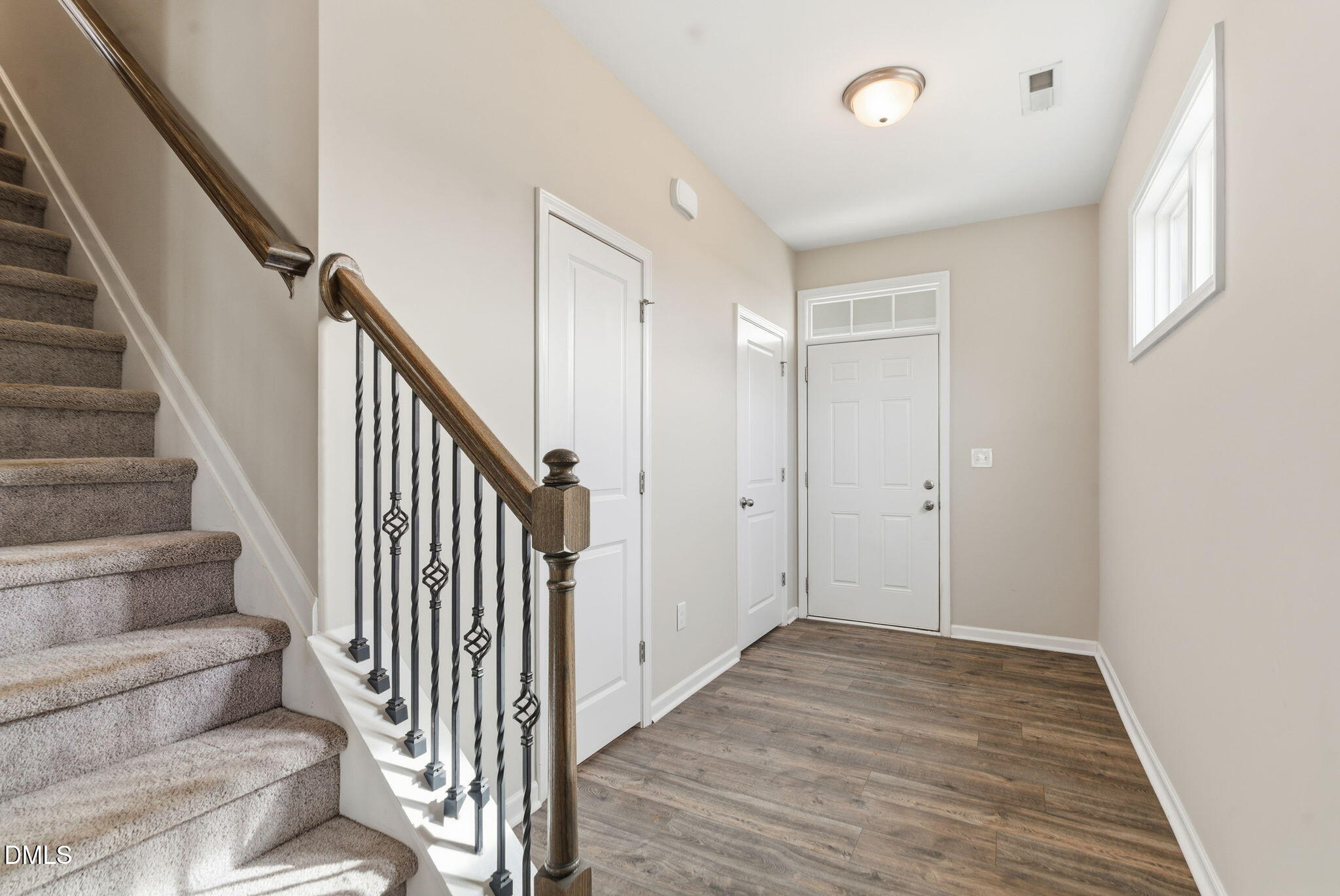 48 Weathervane Dr. Zebulon, NC 27597 - Photo 10 of 68 a view of a hallway with wooden floor and entryway
