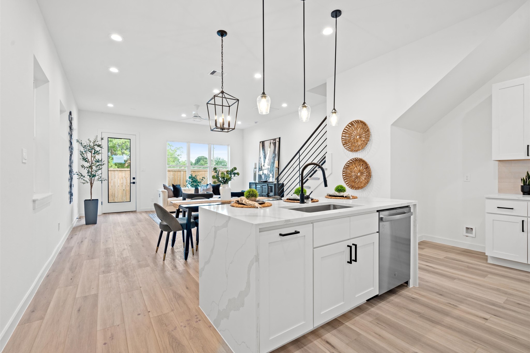 6419 Madrid Street Houston, TX 77021 - Photo 4 of 25 Quartz waterfall island, stainless steel appliances, and modern shaker cabinetry throughout the kitchen