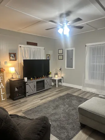 a living room with furniture and a flat screen tv