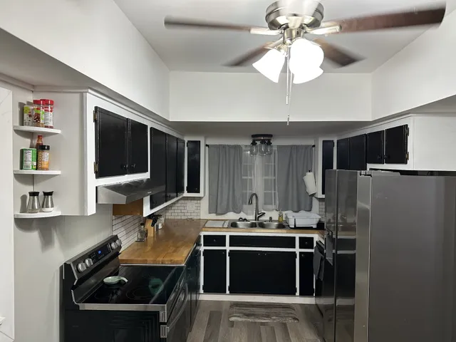 a room with a chandelier furniture and a flat screen tv