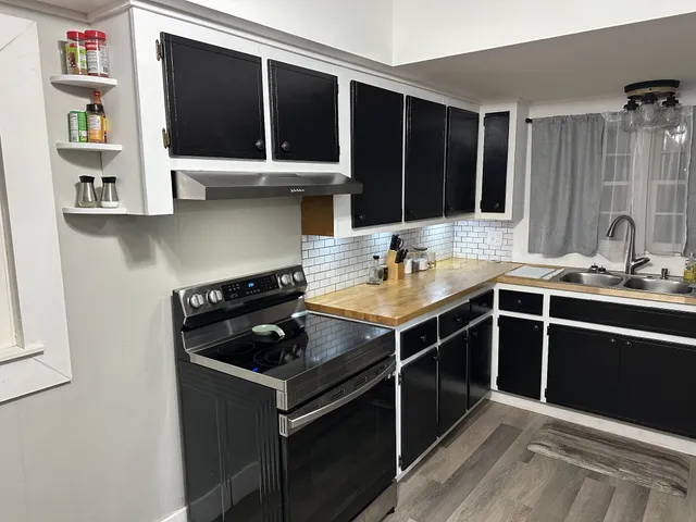 a kitchen with a sink stove and cabinets