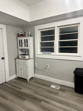 a view of kitchen with wooden floor and window