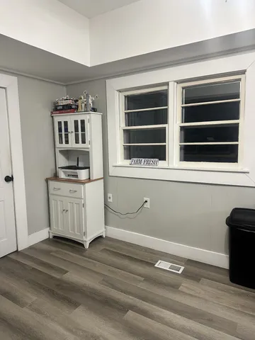 a view of kitchen with wooden floor and window