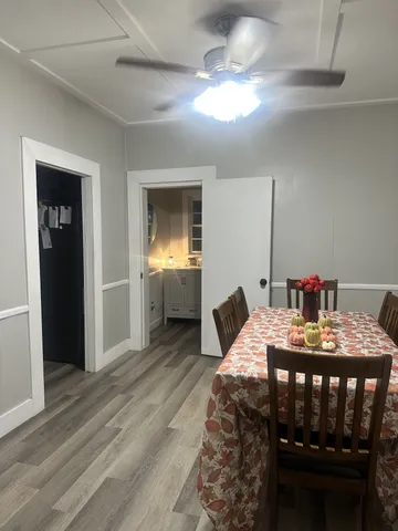a view of a dining room with furniture and wooden floor