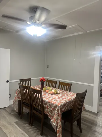 a view of a dining room with furniture and wooden floor