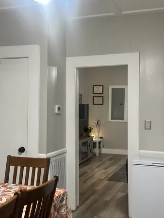 a view of a bedroom with furniture and wooden floor
