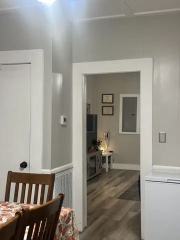 a view of a bedroom with furniture and wooden floor