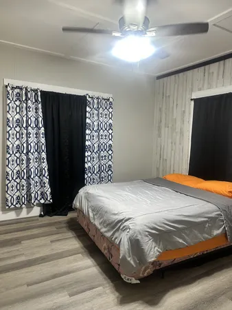 a bedroom with a bed and a mirror