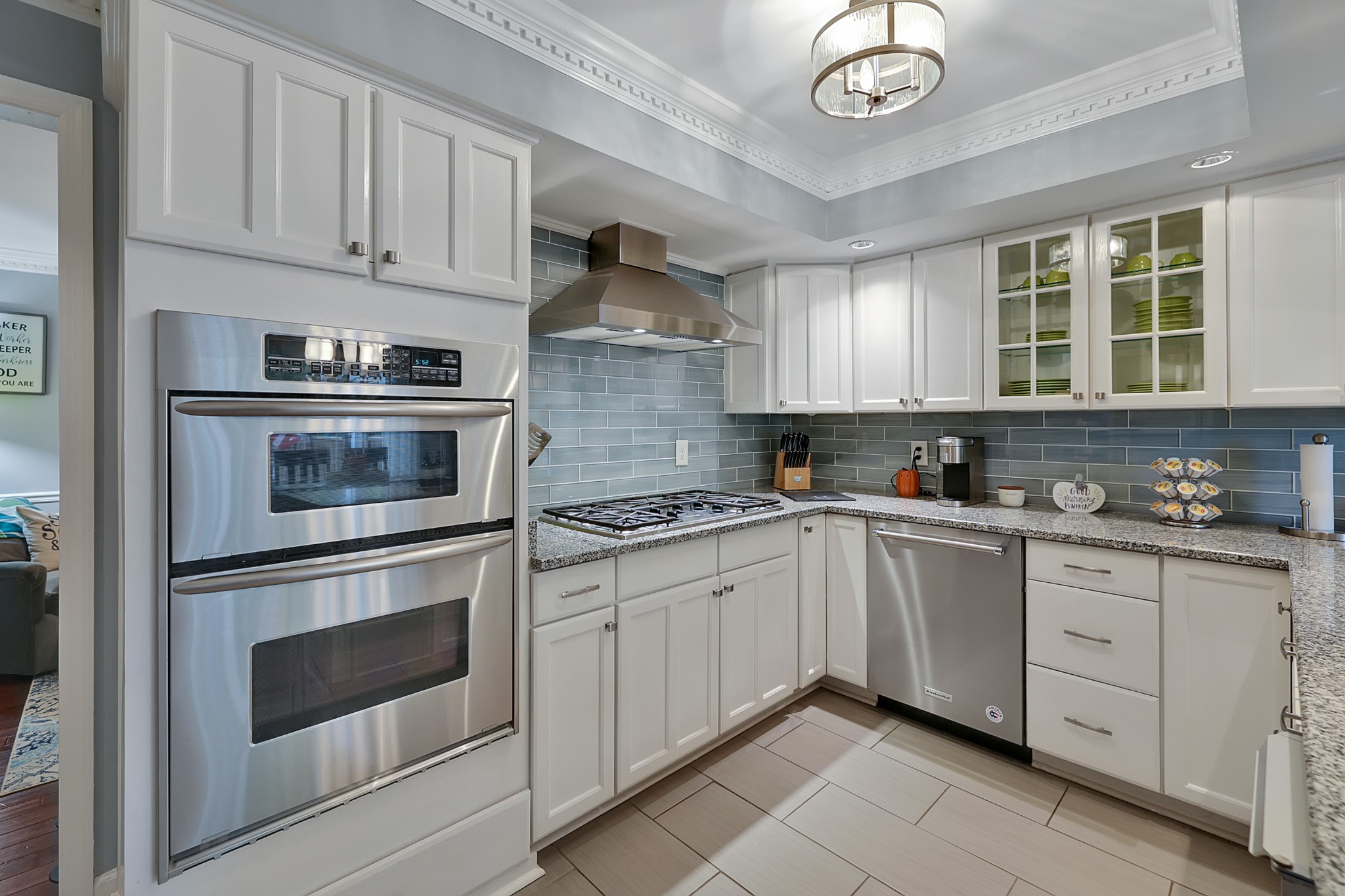 8122 Holly Road Brentwood, TN 37027 - Photo 18 of 65 a kitchen with granite countertop white cabinets stainless steel appliances and a window