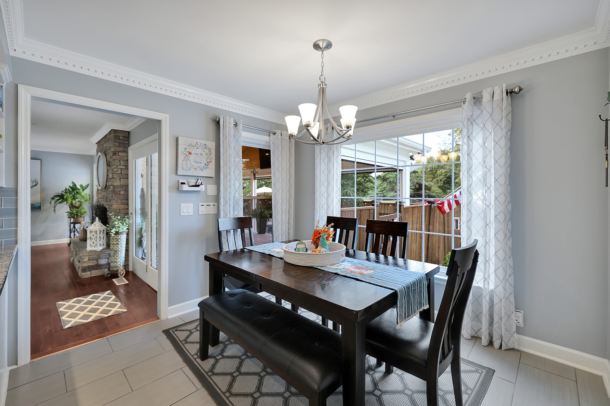 8122 Holly Road Brentwood, TN 37027 - Photo 23 of 65 a view of a dining room with furniture wooden floor and chandelier