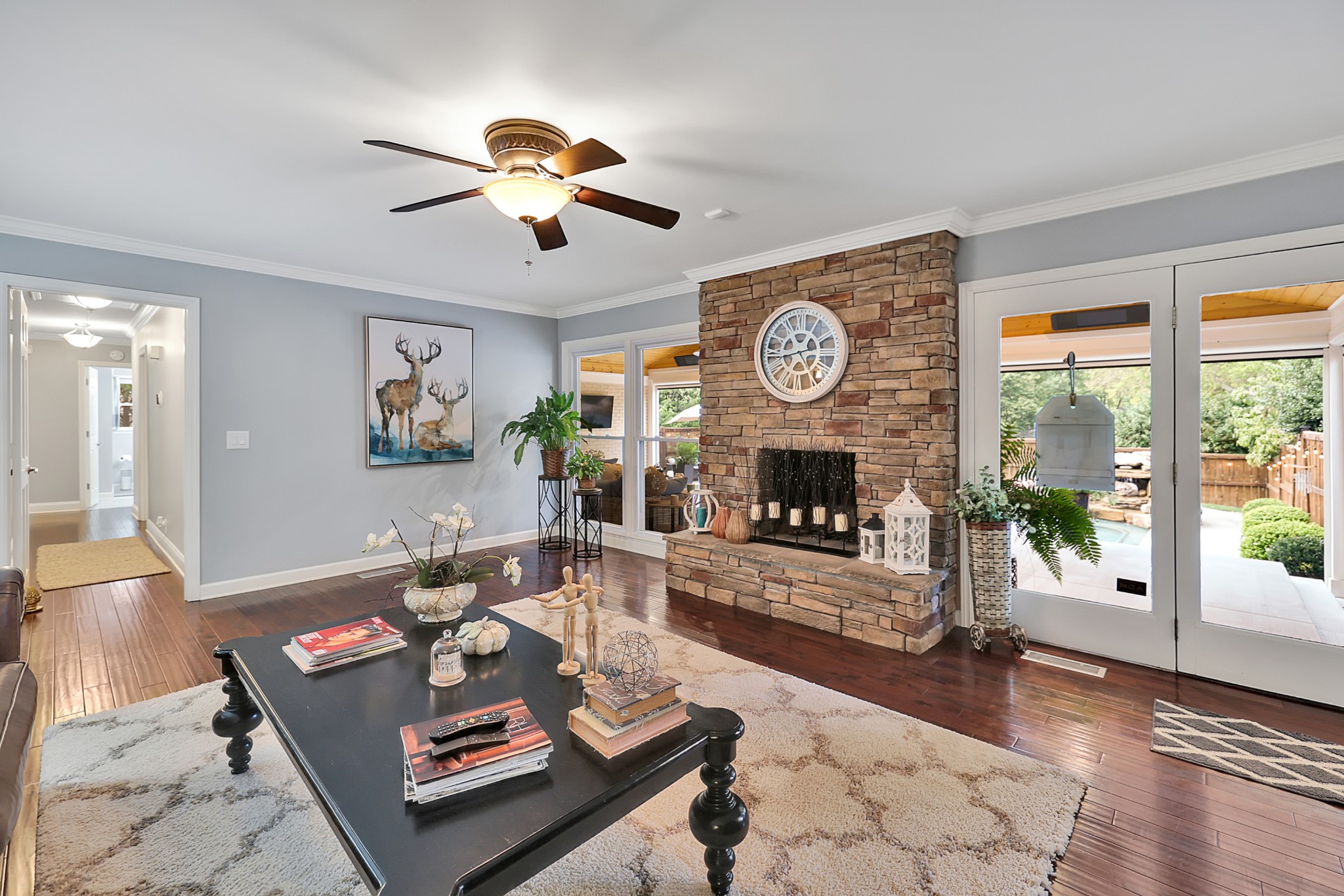 8122 Holly Road Brentwood, TN 37027 - Photo 27 of 65 a living room with furniture a fireplace and a large window