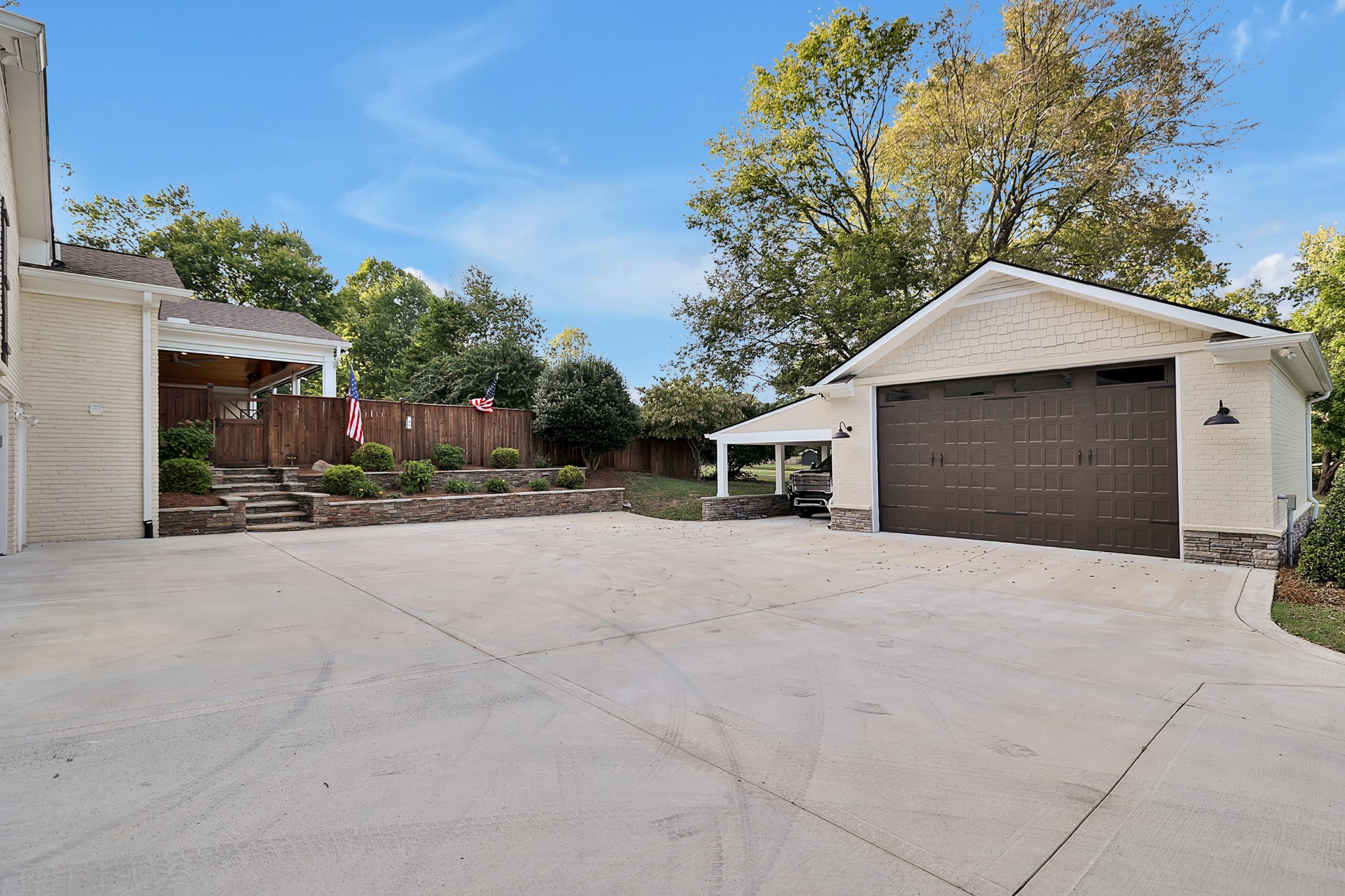 8122 Holly Road Brentwood, TN 37027 - Photo 62 of 65 a front view of a house with a yard and garage