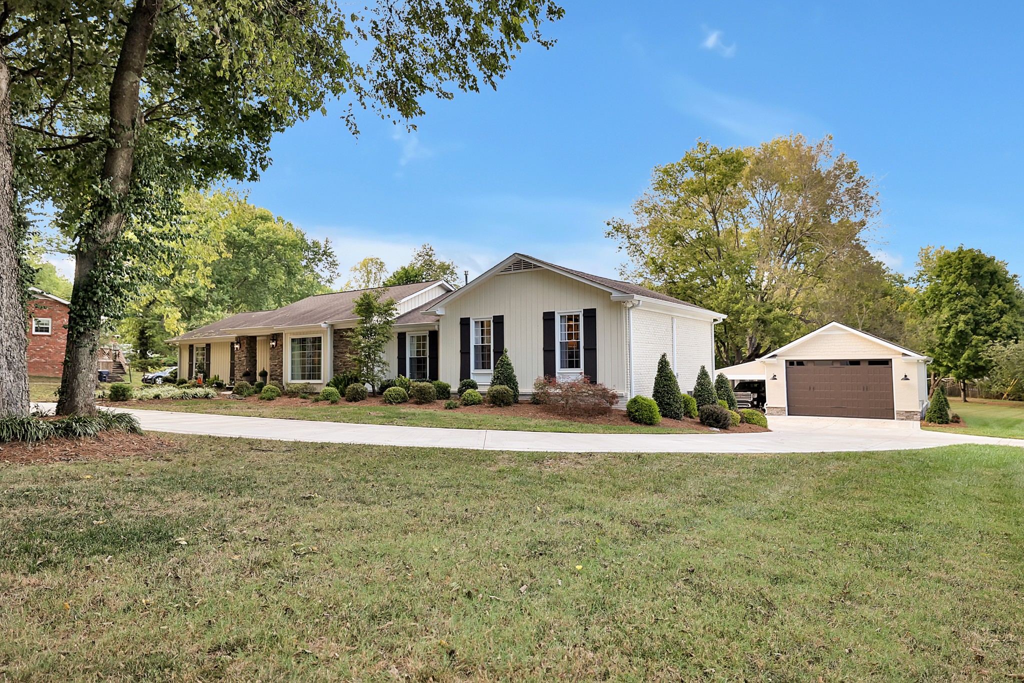 8122 Holly Road Brentwood, TN 37027 - Photo 9 of 65 a front view of a house with a yard and trees