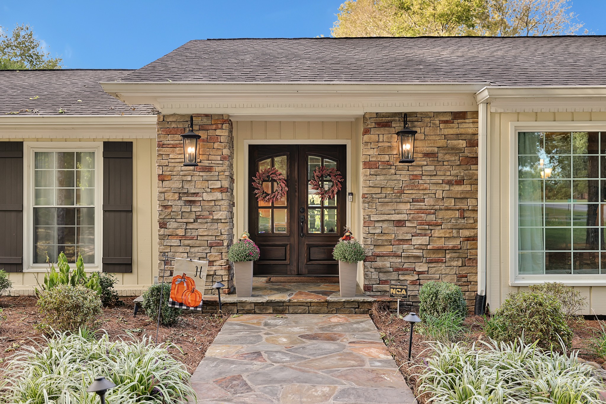 8122 Holly Road Brentwood, TN 37027 - Photo 10 of 65 a front view of a house with potted plants