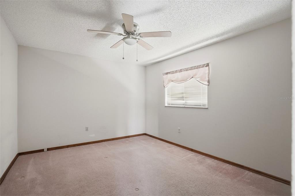 7443 Wabash Trail Spring Hill, FL 34606 - Photo 15 of 40 an empty room with a window and a fan