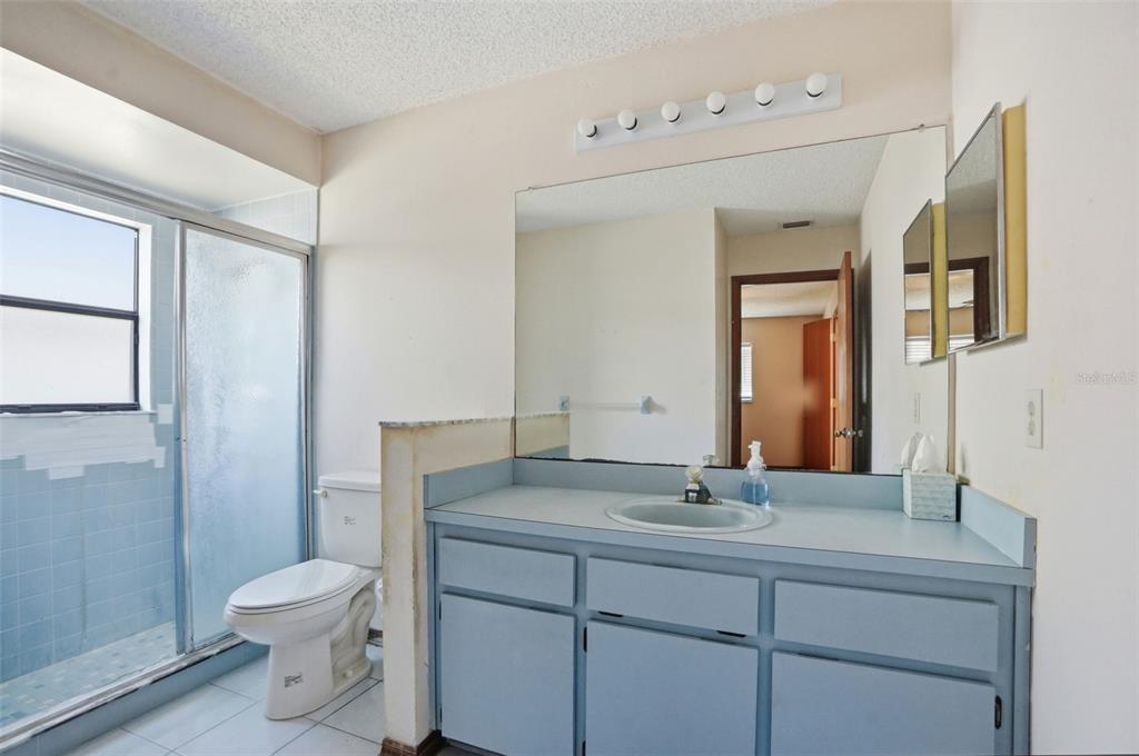 7443 Wabash Trail Spring Hill, FL 34606 - Photo 23 of 40 a bathroom with a toilet a sink and mirror