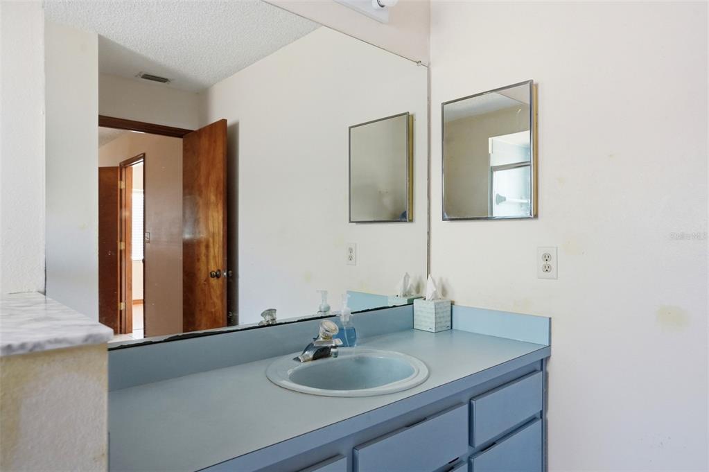 7443 Wabash Trail Spring Hill, FL 34606 - Photo 25 of 40 a bathroom with a sink and a mirror