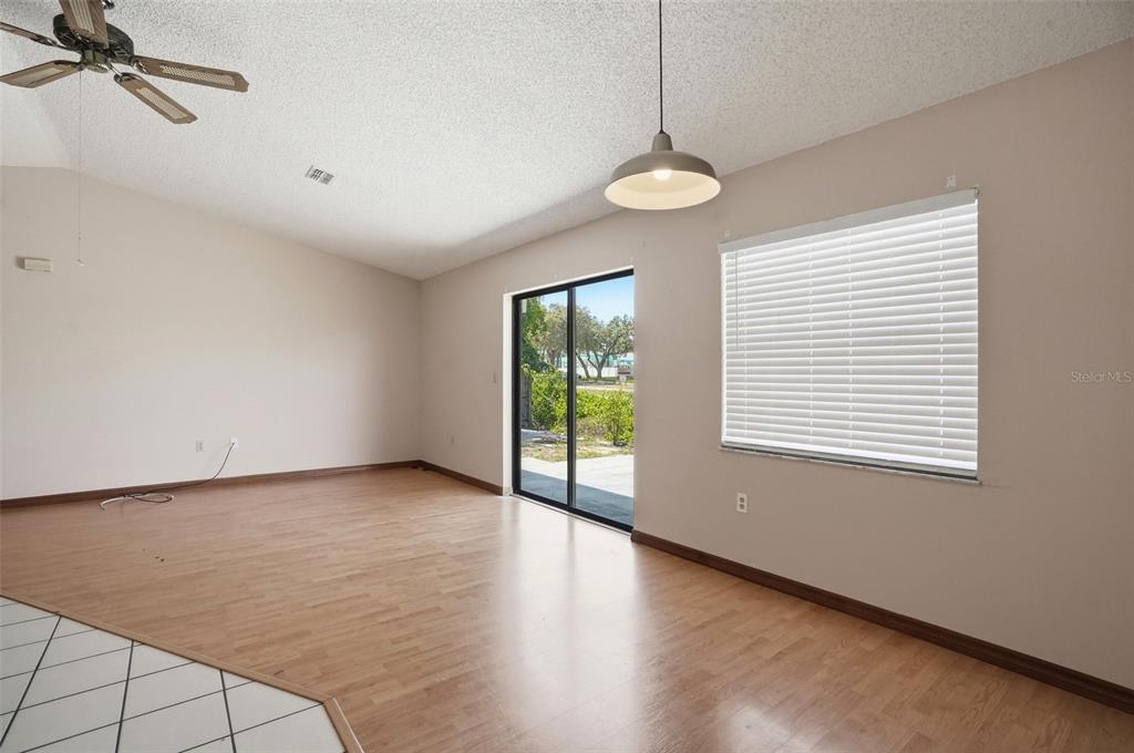 7443 Wabash Trail Spring Hill, FL 34606 - Photo 7 of 40 a view of an empty room with wooden floor and a window