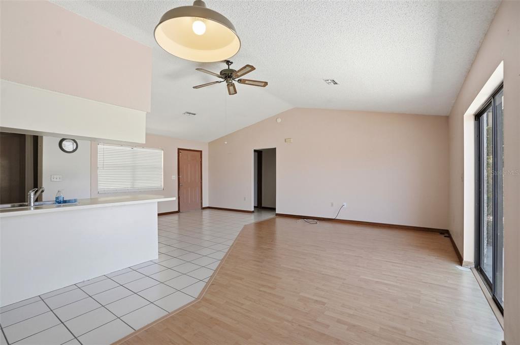 7443 Wabash Trail Spring Hill, FL 34606 - Photo 8 of 40 wooden floor in an empty room with a window