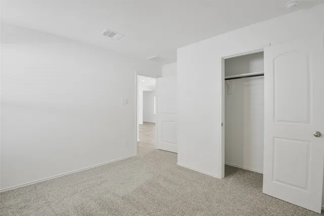 a front view of a house with a garden and yard