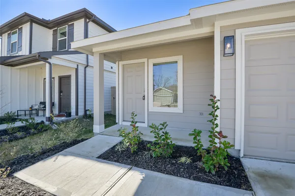 a front view of a house with potted plants