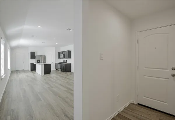 a view of a kitchen with wooden floor