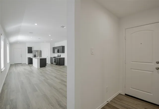 a view of a kitchen with wooden floor
