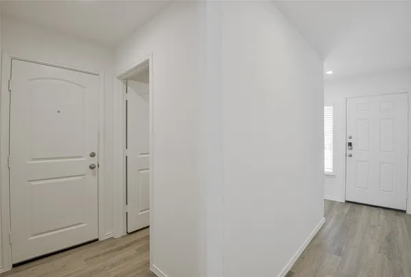 a view of a hallway with wooden floor
