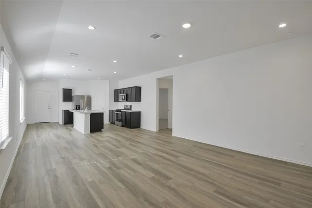 a view of kitchen with refrigerator microwave and stove