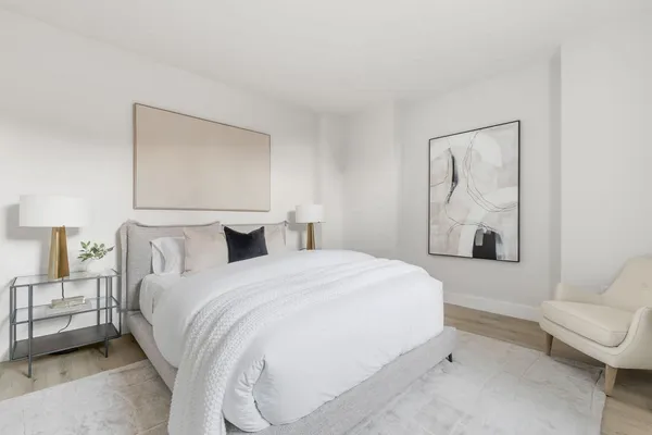 a bedroom with a bed and a couch