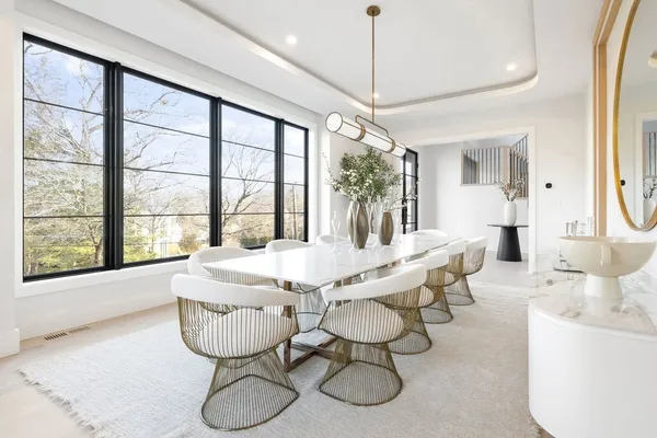 a dining room with furniture a chandelier and window