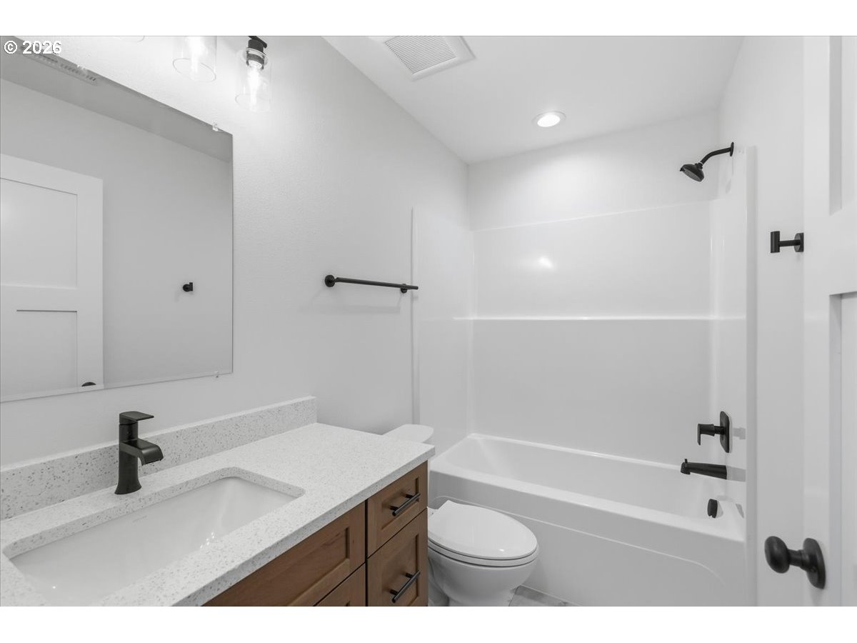 3191 Northwest 23rd Avenue Albany, OR 97321 - Photo 41 of 47 a bathroom with a sink a toilet a mirror and bathtub