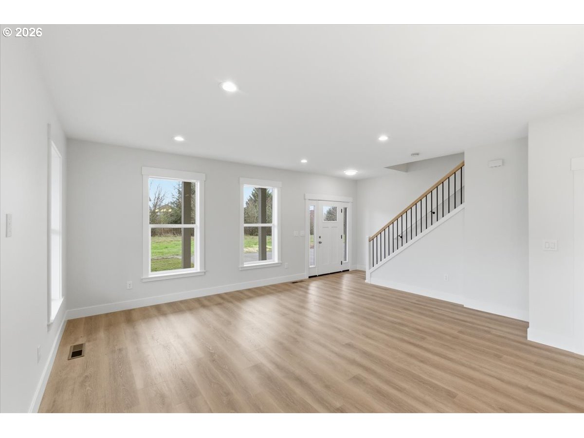 3191 Northwest 23rd Avenue Albany, OR 97321 - Photo 6 of 47 a view of an empty room with wooden floor and windows