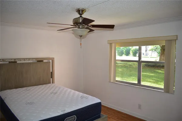 a view of a room with a window and wooden floor