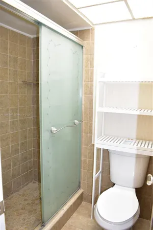 a white toilet sitting next to a bathroom sink