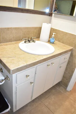 a bathroom with a sink and vanity