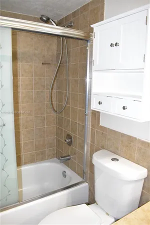 a bathroom with a toilet and shower