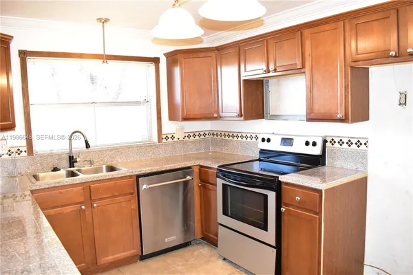 a kitchen with a sink stove and cabinets