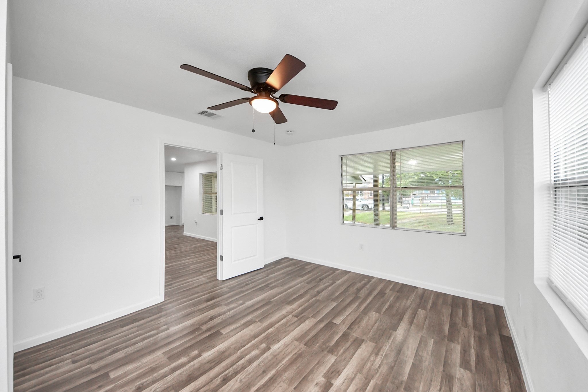 207 East Defee Avenue Baytown, TX 77520 - Photo 26 of 36 a view of empty room with wooden floor and fan