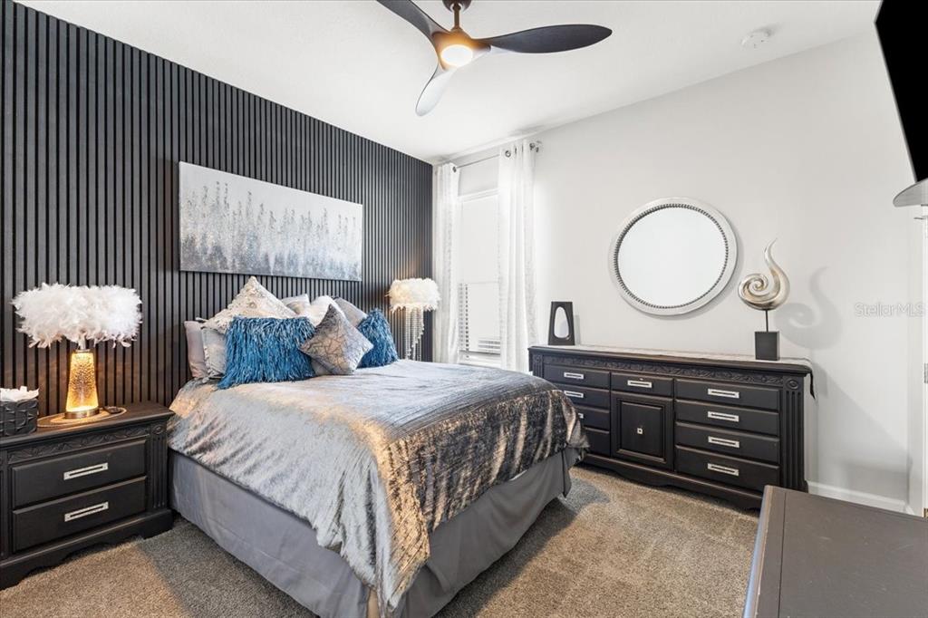 4760 Crestpoint Way Palmetto, FL 34221 - Photo 17 of 44 a bedroom with a bed and a chandelier